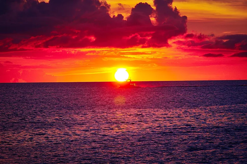 Boat cruising into a Waikiki sunset